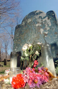 A tribute of flowers and candles at Mrs. Arnold's grave.